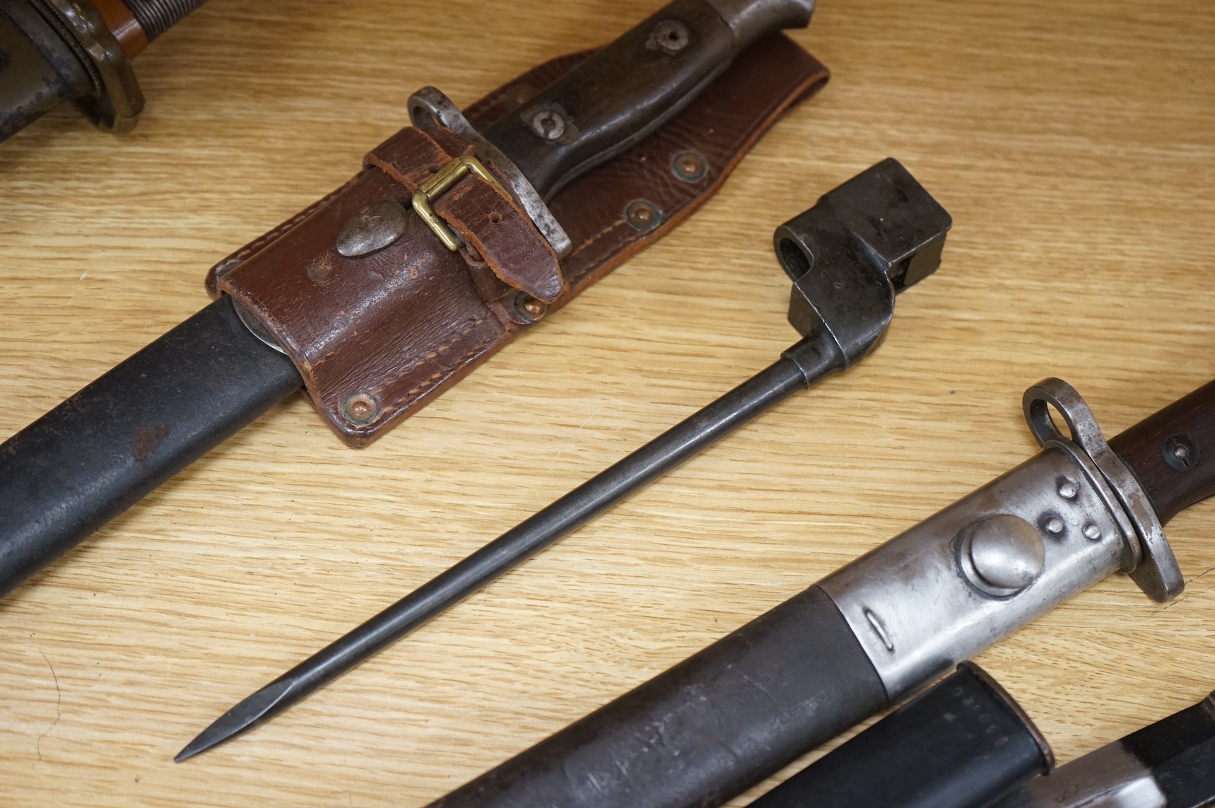 A 1907 bayonet by Wilkinson in its steel mounted leather scabbard, another similar with leather frog, two small British bayonets, a Continental bayonet, and two assorted hunting knives (7)